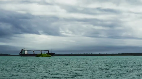 Ferry Passes by the Cargo Ship Stock Footage 41684373