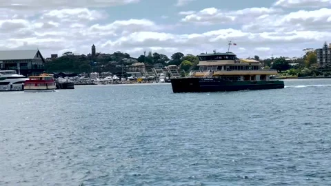 A ferry passing by Barangaroo ferry wharf in Sydney. Public transport for people Stock Footage 166889897