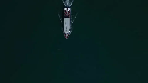 Ferry passing beneath drone top down view Видео 332370648