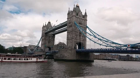 Ferry passing under tower bridge in London Stock Footage 113045675