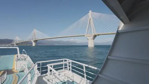Ferry perspective under Rio Antirio bridge with cables and sea Stock Footage 338107701