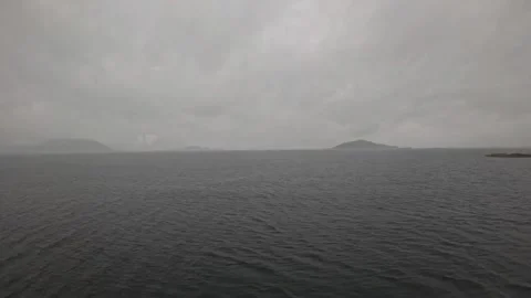 Ferry POV view of dark ocean waters passing small skerry island in Norway Stock-Footage 341814628