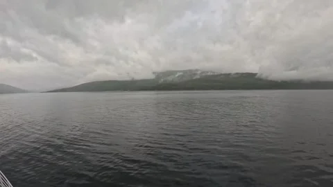 Ferry POV view of misty mountain range and calm fjord waters in Northern Norway Stock-Footage 341814667