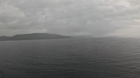 Ferry POV view of moody overcast skies and misty mountain coast in Norway Stock-Footage 341814627