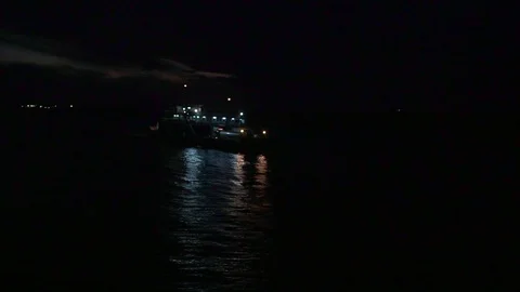 Ferry reaching the port at night Stock Footage 127977256