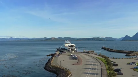 Ferry rests at quiet dock along Norway rugged coastline, aerial view Stock Footage 320732942
