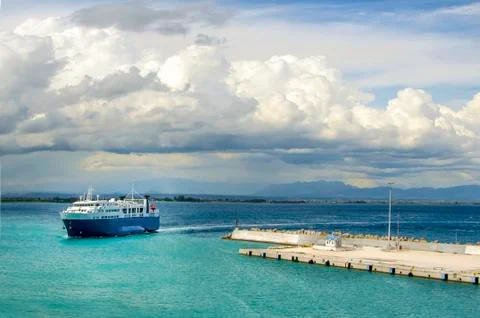 Ferry returning to port under a dramatic sky Stock Photos