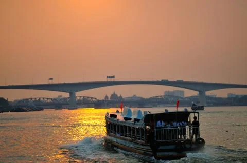 A Ferry on a River at Sunset Stock Photos