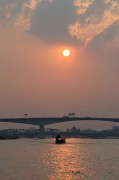 A Ferry on a River at Sunset Stock Photos