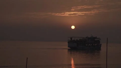 A ferry is sailing across the river at sunset Stock Footage 156256682