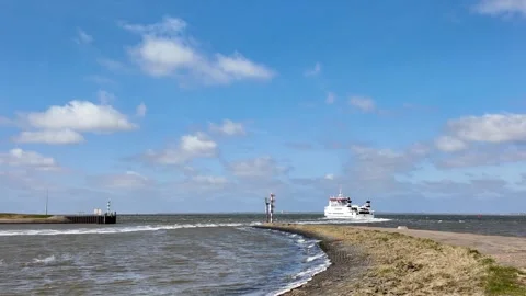 Ferry sailing on open Wadden Sea toward Schiermonnikoog, seen from the pier Stock Footage 336406912
