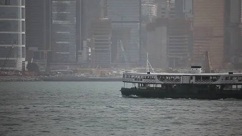 Ferry sailing in the river in front of Hong Kong skyline Stock Footage 97101937