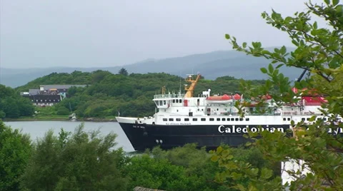 Ferry sailing through a loch, pan left Stock Footage 39815865