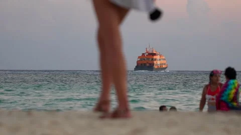 Ferry ship with passengers tourists in the open ocean, shot from the beach Stock Footage 166645238