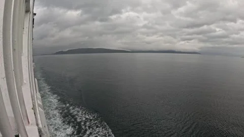 Ferry side POV view of white ship wake on dark fjord waters in Norway Vidéo 341814666
