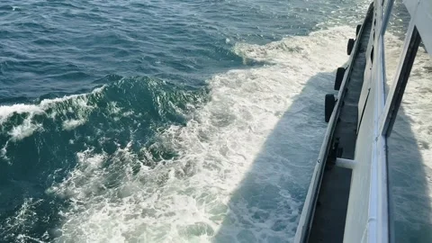Ferry side view with foamy sea waves trailing along the vessel Stock Footage 321392277