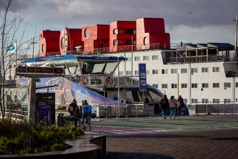 Ferry stop NDSM with Botel in the background Stock Photos