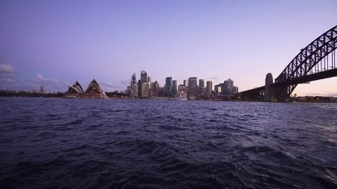Ferry to Sydney CDB harbor with sunset illuminated city building Stock Footage 124908755