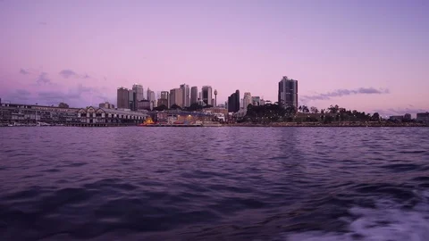 Ferry to Sydney CDB harbor with sunset illuminated city building Stock Footage 124996119