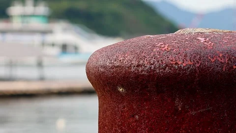 Ferry View Framed by an Abandoned and Rusted Mooring Bollard,01 库存影片 343821471