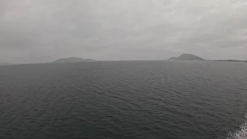 Ferry view of open sea and distant Norwegian islands under overcast sky 스톡 동영상 341814622