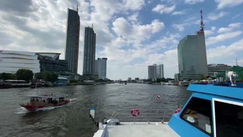 Ferryboat in Chao Phraya river next to high rise buildings, Bangkok, Thailand 4K Stock Footage 175223801
