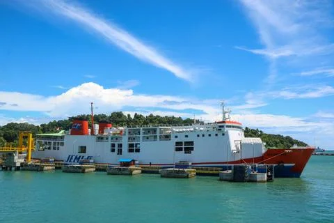 Ferryboat loading or unloading by a port pier. Stock Photos