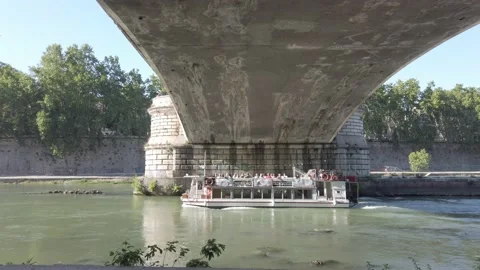 Ferry/boat passes under a bridge on the river tiber. Italy, Rome. Video stock 232344012