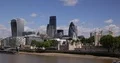 Ferryboat Passing on Thames River in front of London Tower and Office Skyscraper 4k or 4k+ Resolution