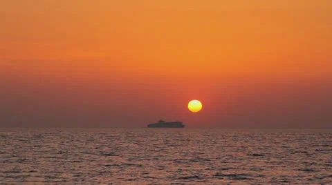 Ferryboat passing under the sun at sunset Stock Footage 25984993