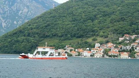 Ferryboats float between coastal towns at the shores of Kotor Bay. Montenegro Stock Footage 94025908