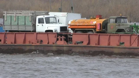 Ferrying vehicles across the river on a barge Stock Footage 144757866