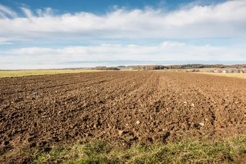 Fertile fields and green and brown soil Stock Photos