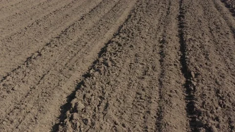 Fertile soil furrows made with plough 4K drone footage Stock Footage 105302145