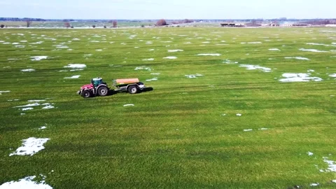 Fertilizer application, spring, winter wheat field, snow islands Stock Footage 150248594