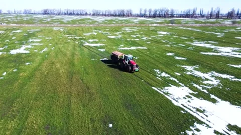 Fertilizer application, spring, winter wheat field, snow islands Stock Footage 150248634