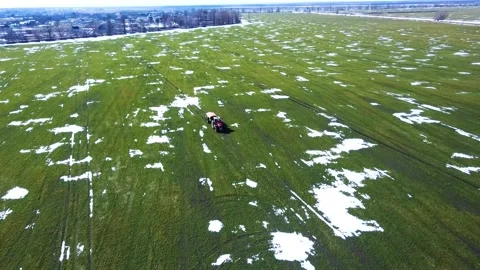 Fertilizer application, spring, winter wheat field, snow islands Stock Footage 150248733