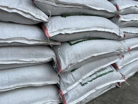 Fertilizer bag being stacked in front of a plant shop Stock Photos