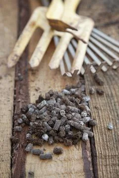 Fertilizer pellets on a workbench. Stock Photos