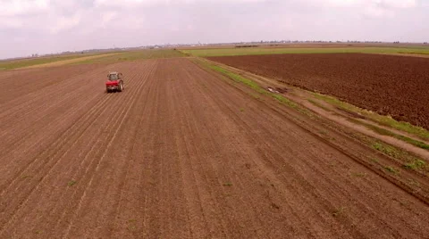 Fertilizer spreading on the field drone aerial shot Stock Footage 56301864