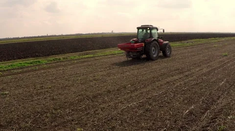 Fertilizer spreading on the field drone daigonal shot  Stock Footage 56301318