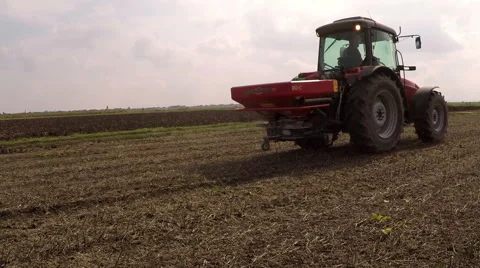 Fertilizer spreading on the field drone shot Stock Footage 56301282
