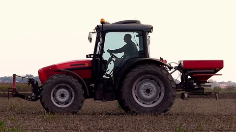 Fertilizer spreading on the field slow motion Stock Footage 56041109