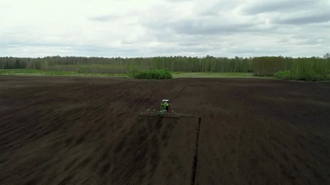 Fertilizing Land, Sowing Wheat Seed into Soil, Summer Planting Season. Tractor Stock Footage 127987861
