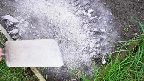 Fertilizing the soil of the bed with coal and ash in the spring before planting Stock Footage 149167059