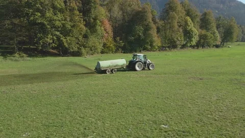 Fertilizing with a tractor, pouring slurry over the lawn 2 Stock Footage 223856391