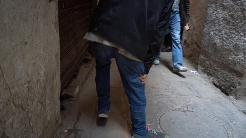 Fes Morocco. March 23 2019. Cripple man walking in a medieval arab alley Stock Footage 108150562