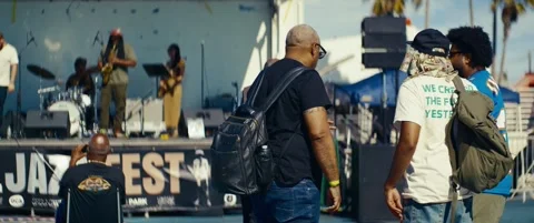 Festival Attendees Chat in Front of a Live Music Stage Stock Footage 344814640