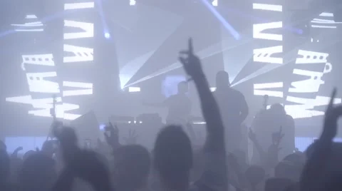 Festival crowd dancing jumping up for music drop lasers smoke slow motion Stock Footage 68709177