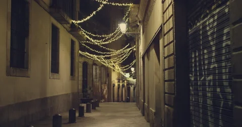 Festival decorative string lights hang and glow outdoors at night. Warm lighting 動画素材 140971652